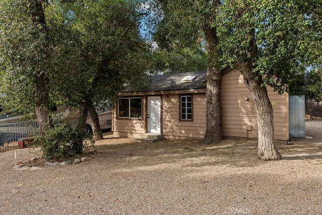 view of outbuilding featuring fence