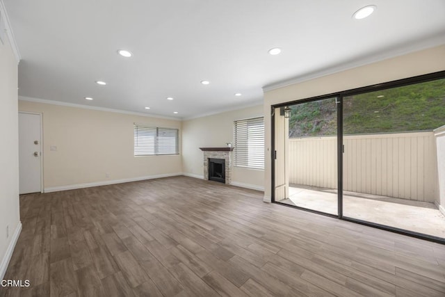 10508 Sunland Blvd Unit 4, Sunland, CA 91040 - unfurnished living room featuring a fireplace, a wealth of natural light, crown molding, and recessed lighting