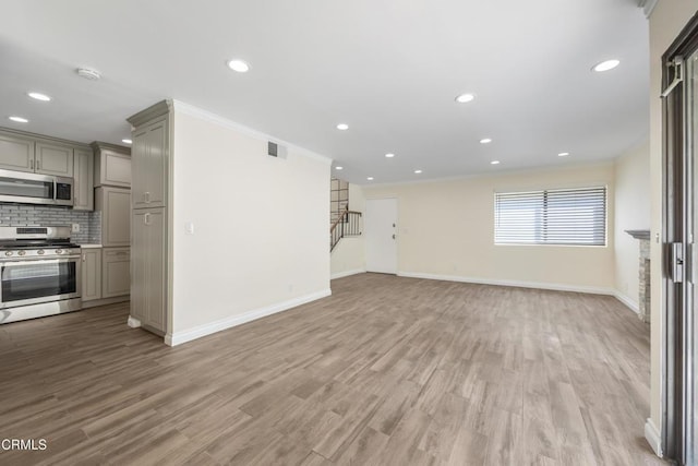 10508 Sunland Blvd Unit 4, Sunland, CA 91040 - unfurnished living room with visible vents, baseboards, recessed lighting, stairway, and crown molding