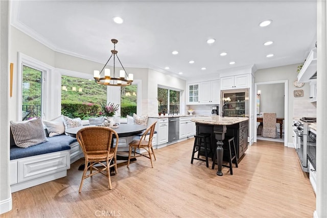 interior space featuring recessed lighting, ornamental molding, light wood-style flooring, and a chandelier