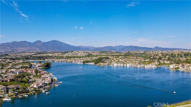 birds eye view of property with a water and mountain view