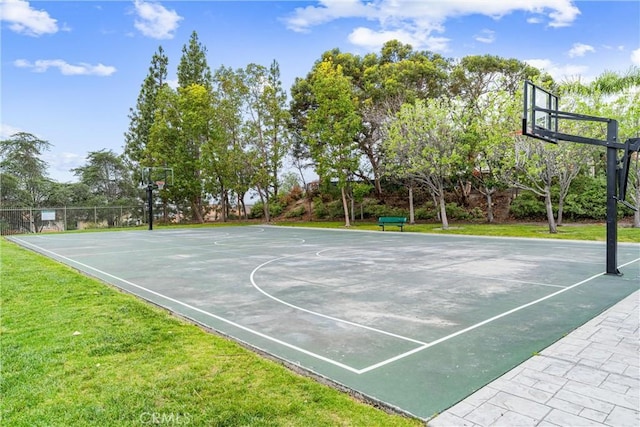 view of sport court with a lawn and community basketball court