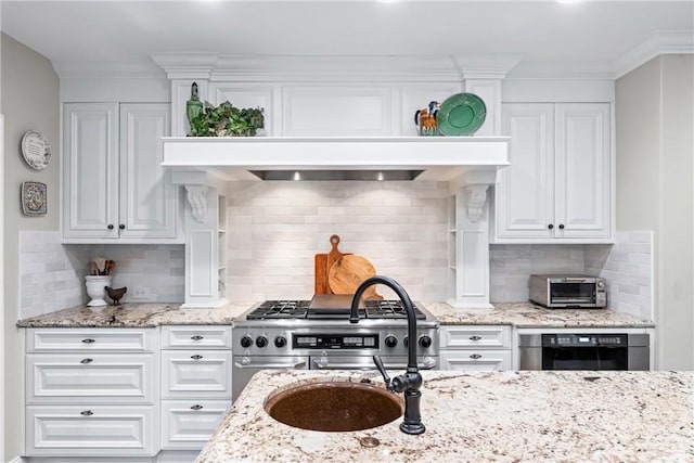 kitchen featuring white cabinetry, decorative backsplash, and stainless steel appliances