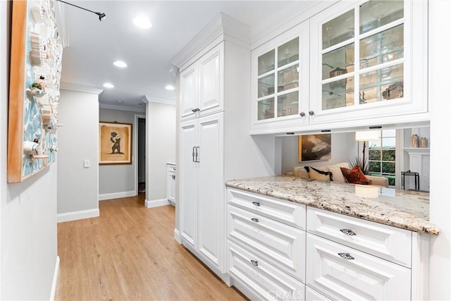bar featuring baseboards, ornamental molding, recessed lighting, and light wood-style flooring
