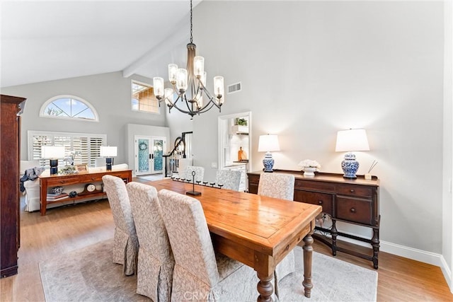dining room featuring visible vents, beam ceiling, stairway, a notable chandelier, and light wood-style floors