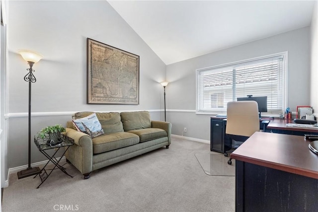 home office with baseboards, lofted ceiling, and light carpet
