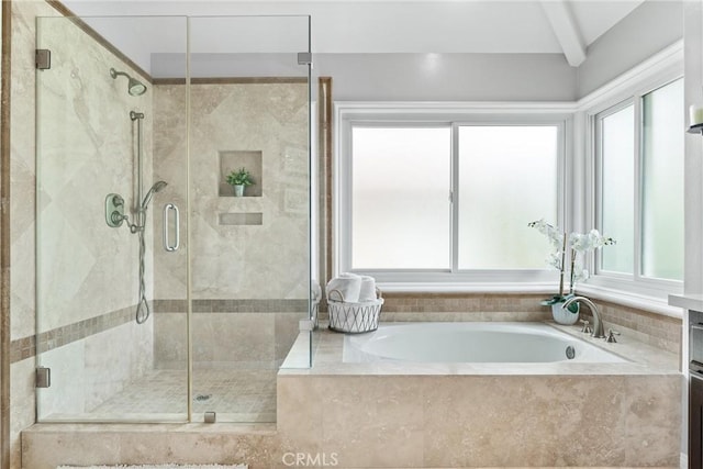 full bath with a bath, a healthy amount of sunlight, and a shower stall