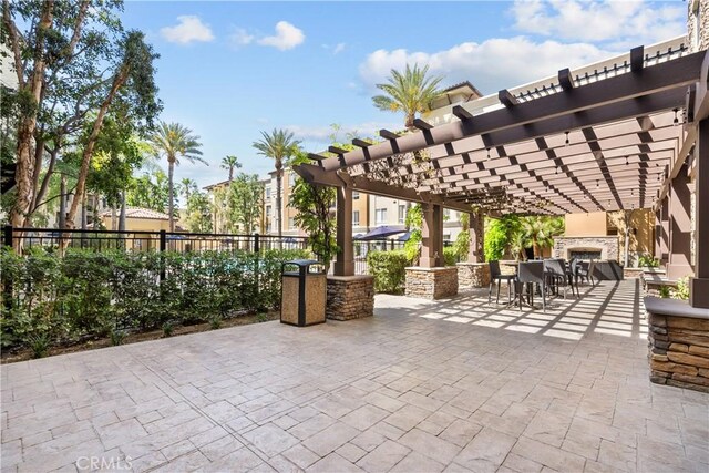 24535 Town Center Dr Unit 6309, Valencia, CA 91355 - view of patio featuring a pergola and exterior fireplace