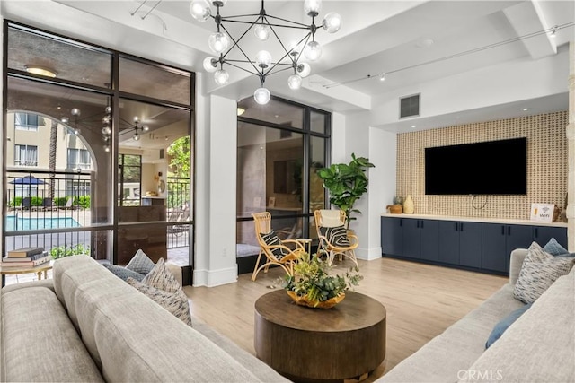 24535 Town Center Dr Unit 6309, Valencia, CA 91355 - living area featuring a chandelier, light wood finished floors, and baseboards