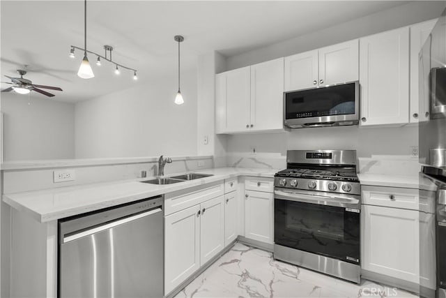 24535 Town Center Dr Unit 6309, Valencia, CA 91355 - kitchen with appliances with stainless steel finishes, a sink, light marble finish flooring, a peninsula, and a ceiling fan