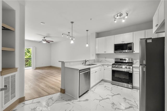 24535 Town Center Dr Unit 6309, Valencia, CA 91355 - kitchen featuring stainless steel appliances, a sink, light marble finish floors, a peninsula, and light countertops