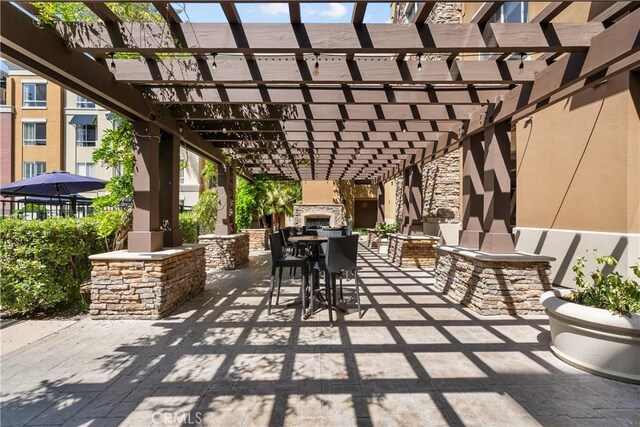 24535 Town Center Dr Unit 6309, Valencia, CA 91355 - view of patio / terrace with an outdoor stone fireplace and a pergola