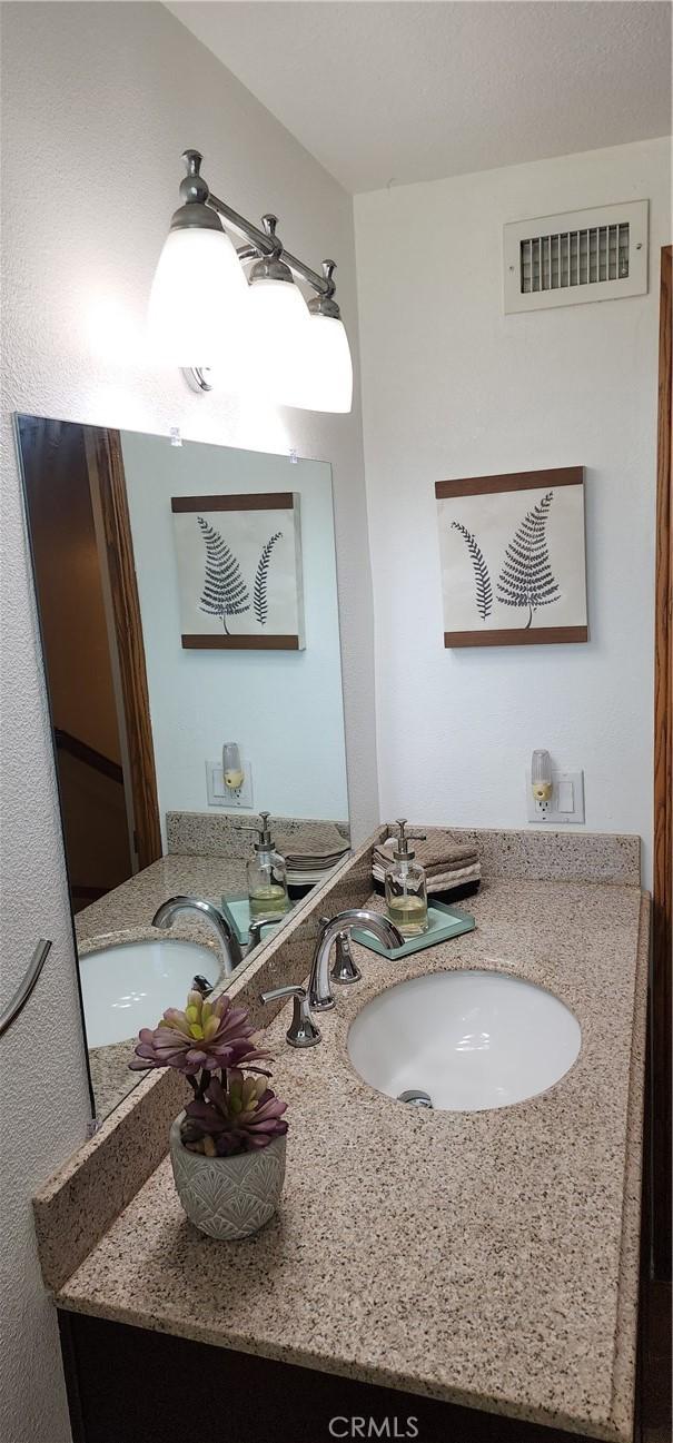 bathroom with visible vents and a sink