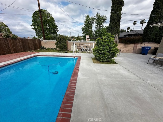 view of pool with a fenced in pool, a fenced backyard, and a patio area