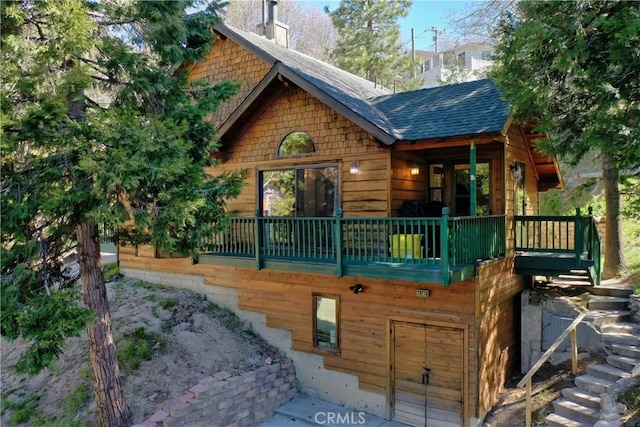 29278 Pine Dr, Cedar Glen, CA 92321 - back of property with a shingled roof and a chimney