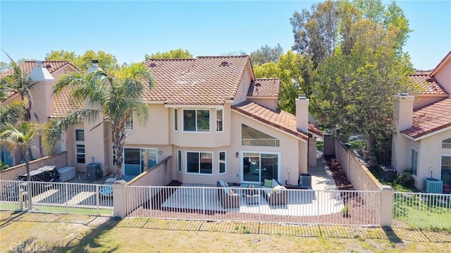 back of property with a tile roof, central AC unit, a patio area, a fenced backyard, and stucco siding