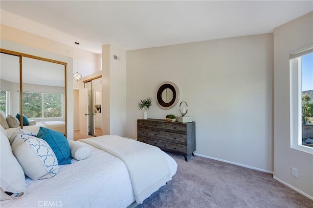 bedroom featuring carpet floors, baseboards, visible vents, and lofted ceiling