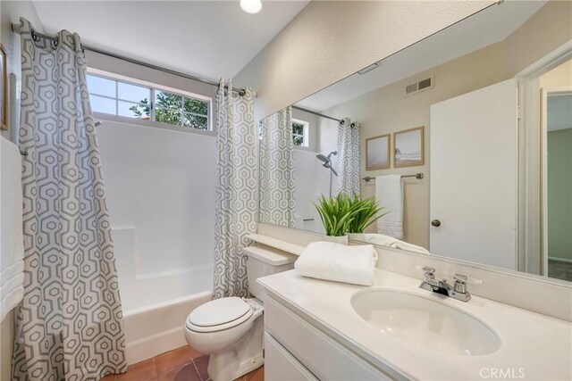 full bathroom with tile patterned flooring, vanity, toilet, shower / bathtub combination with curtain, and visible vents