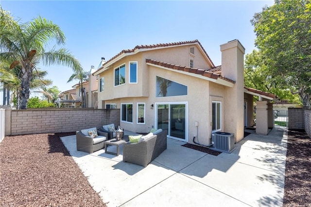 rear view of property with central air condition unit, a fenced backyard, stucco siding, and an outdoor hangout area