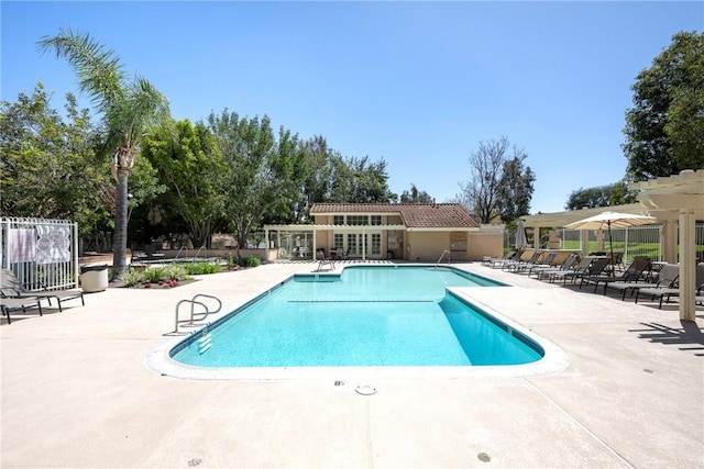 community pool with fence and a patio