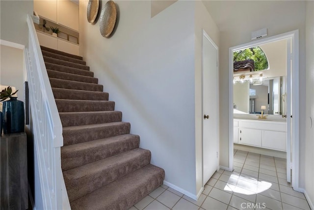 stairs featuring tile patterned flooring and baseboards