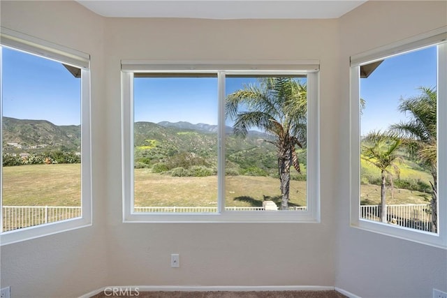 interior space with baseboards and a mountain view