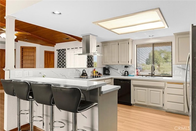 22975 Flournoy Ave, Corning, CA 96021 - kitchen featuring a sink, light wood-type flooring, island range hood, a breakfast bar, and black appliances