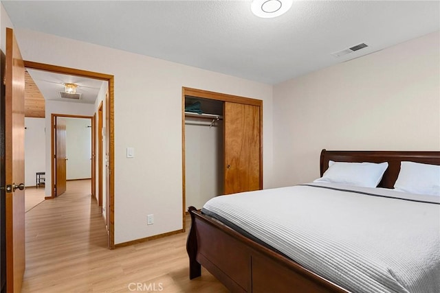 22975 Flournoy Ave, Corning, CA 96021 - bedroom featuring baseboards, light wood finished floors, visible vents, and a closet