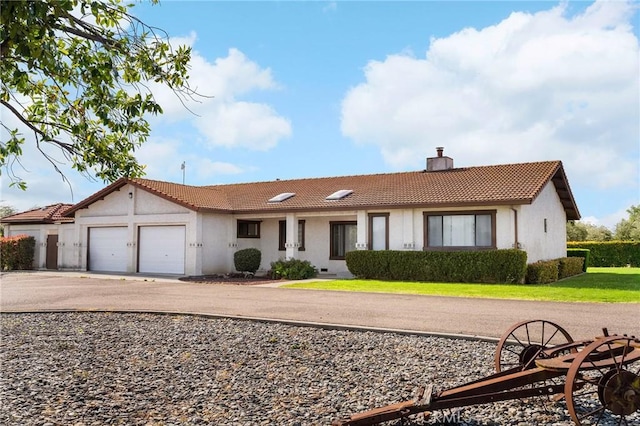 22975 Flournoy Ave, Corning, CA 96021 - ranch-style house featuring an attached garage, a tiled roof, a chimney, and stucco siding