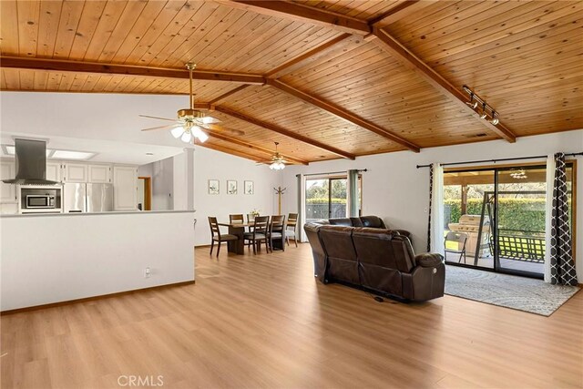 22975 Flournoy Ave, Corning, CA 96021 - living room with lofted ceiling with beams, track lighting, light wood-style floors, ceiling fan, and wooden ceiling