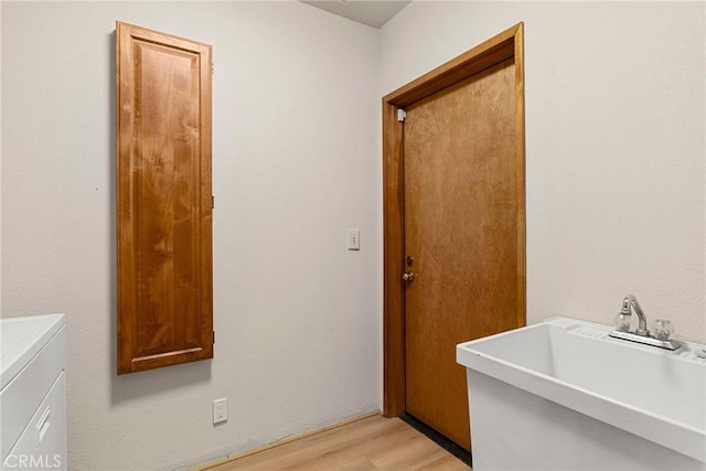 22975 Flournoy Ave, Corning, CA 96021 - washroom with cabinet space, light wood-type flooring, washer and dryer, and a sink