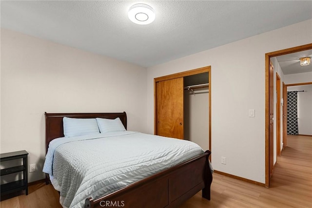 22975 Flournoy Ave, Corning, CA 96021 - bedroom featuring baseboards, a closet, and light wood-type flooring