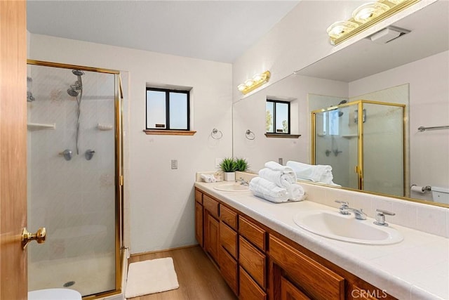 22975 Flournoy Ave, Corning, CA 96021 - full bathroom with a shower stall, wood finished floors, a sink, and double vanity