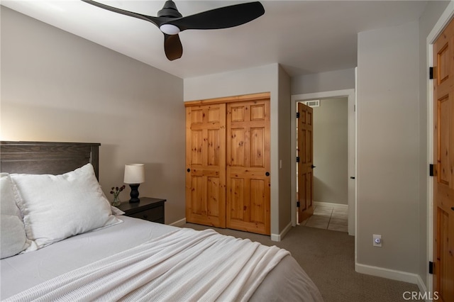 carpeted bedroom featuring baseboards and a ceiling fan