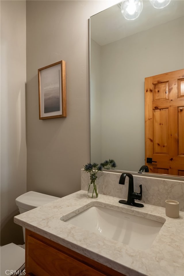 bathroom featuring toilet and vanity