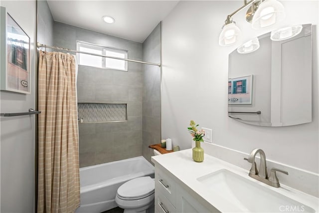 full bathroom featuring shower / bath combination with curtain, toilet, and vanity