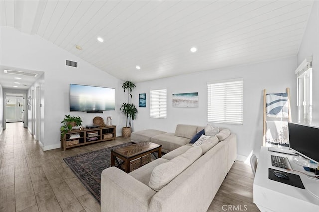 living area featuring lofted ceiling, wood finished floors, visible vents, and recessed lighting