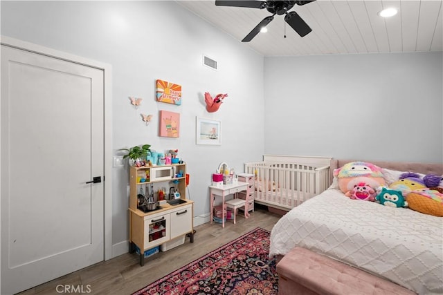 bedroom with wood finished floors, ceiling fan, baseboards, visible vents, and recessed lighting