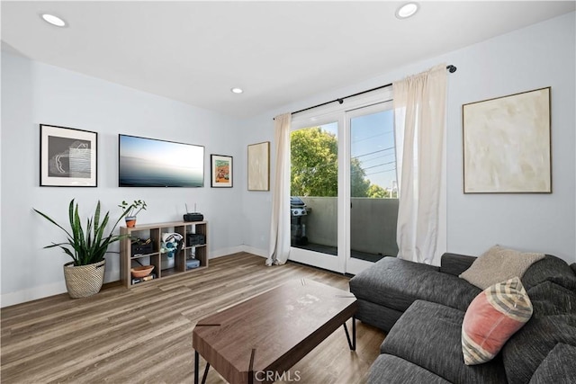 living room featuring recessed lighting, wood finished floors, and baseboards