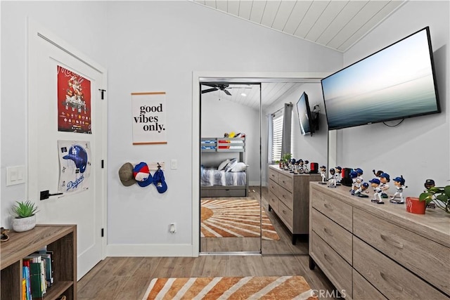 bedroom with baseboards, vaulted ceiling, wooden ceiling, and light wood-style floors