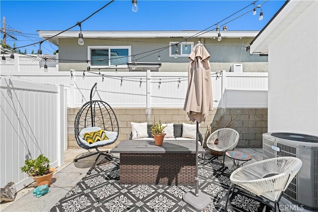 view of patio / terrace featuring central air condition unit, a fenced backyard, and an outdoor living space