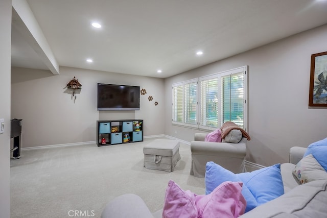 carpeted living area with baseboards and recessed lighting