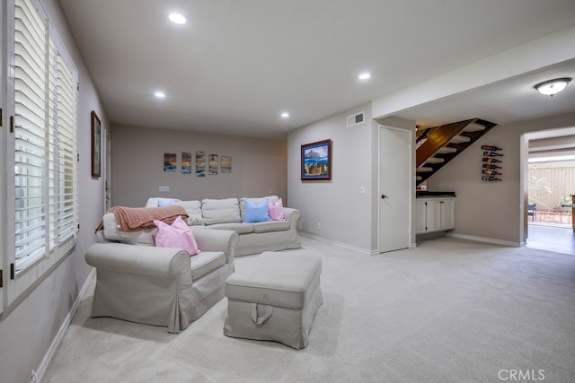 living room featuring recessed lighting, visible vents, light carpet, and baseboards