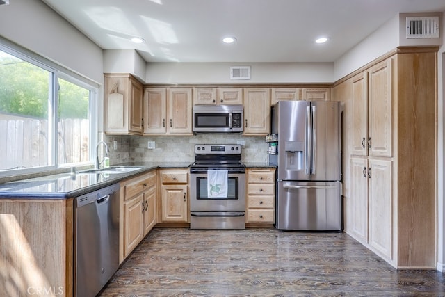 kitchen featuring light brown cabinets, visible vents, stainless steel appliances, and a sink
