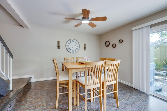 dining space featuring baseboards, wood finished floors, ceiling fan, and stairs