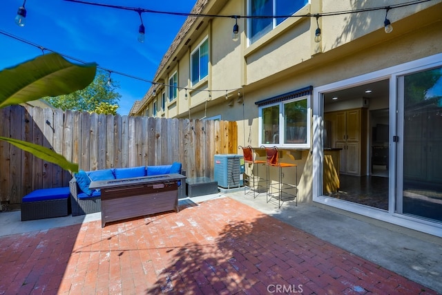 view of patio featuring fence, cooling unit, and a hot tub