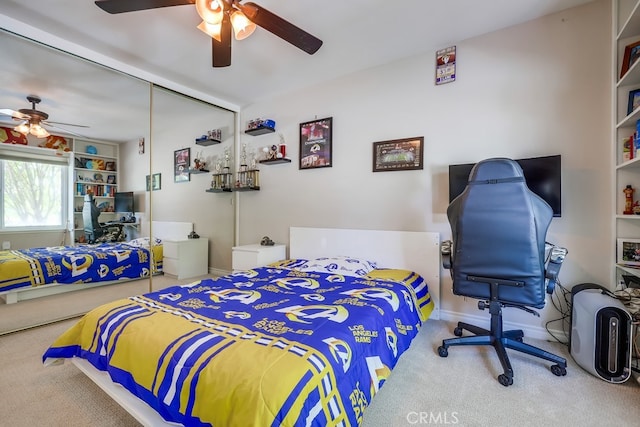 carpeted bedroom with a ceiling fan and baseboards