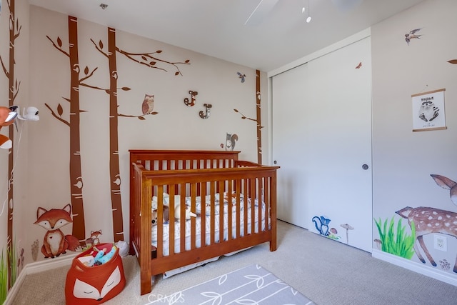carpeted bedroom featuring a closet and a crib