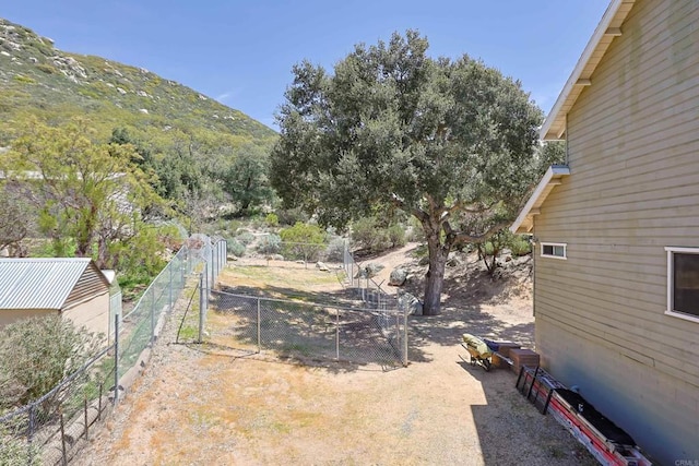 view of yard with fence and a mountain view