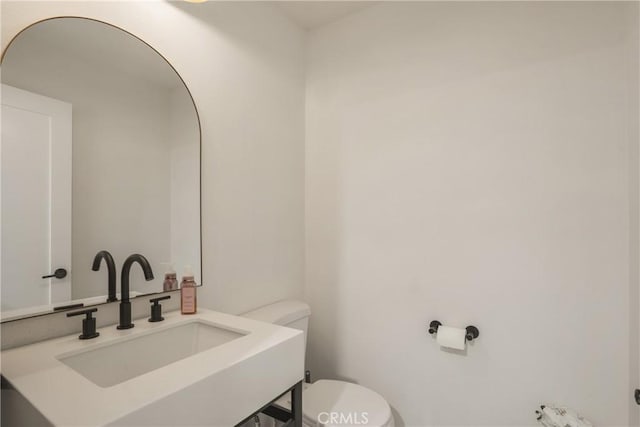 bathroom with toilet and a sink